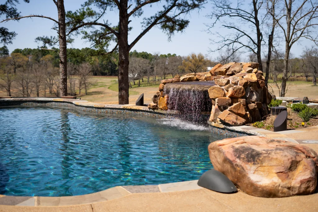 Luxurious pool with waterfall located in Bartonville, TX.