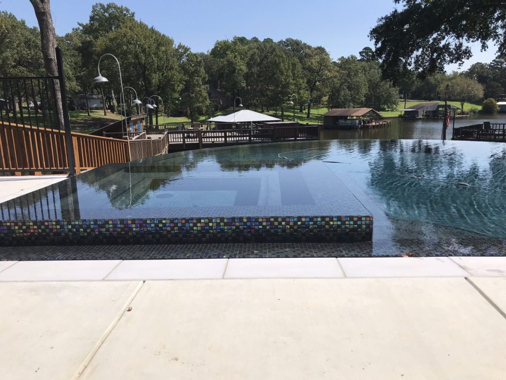 Custom gunite pool with fire feature and outdoor living space in Texas